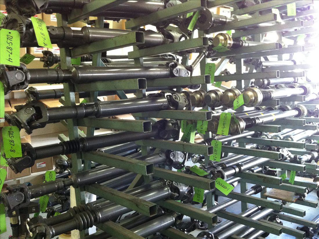 Rack of finished, tagged drive shafts ready for customers